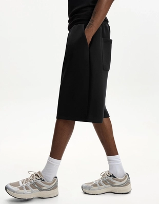 Шорты оверсайз из плотной синтетической ткани- Заказать в России