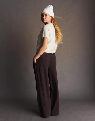 Брюки объемного кроя из двухслойной ткани- Заказать в России