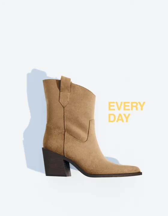 Asymmetric heeled cowboy ankle boots