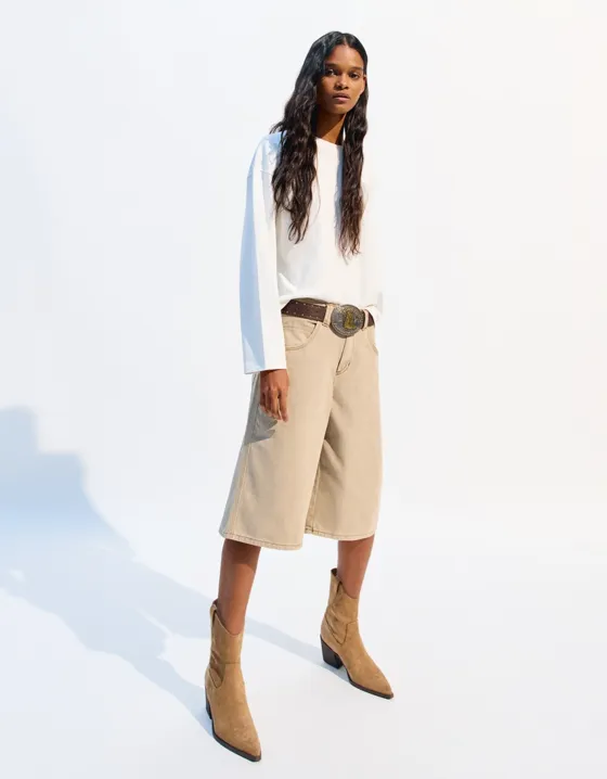 Asymmetric heeled cowboy ankle boots